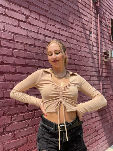 tan crop top with long sleeves and a v neck