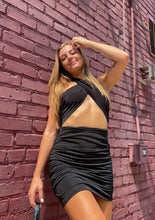Load image into Gallery viewer, black cross halter dress with open stomach and stretchy material

